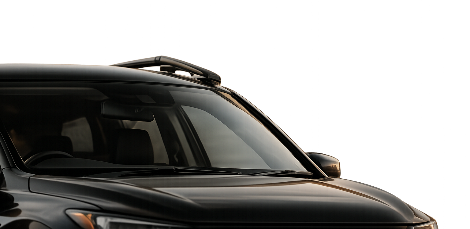 Close-up of a modern black SUV with a sleek design, showing the front side and windshield.
