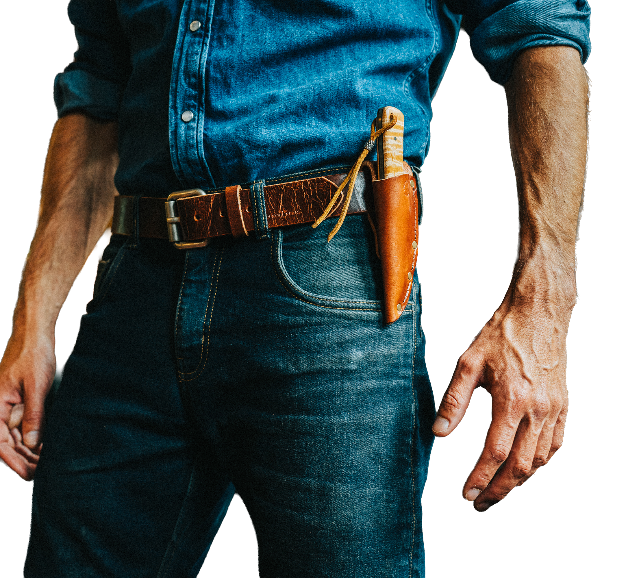 Close-up of a person wearing a denim shirt with rolled-up sleeves, a brown leather belt, and a pocket with tools including a knife and a leather punch. The person's right hand is visible at the bottom right of the image.