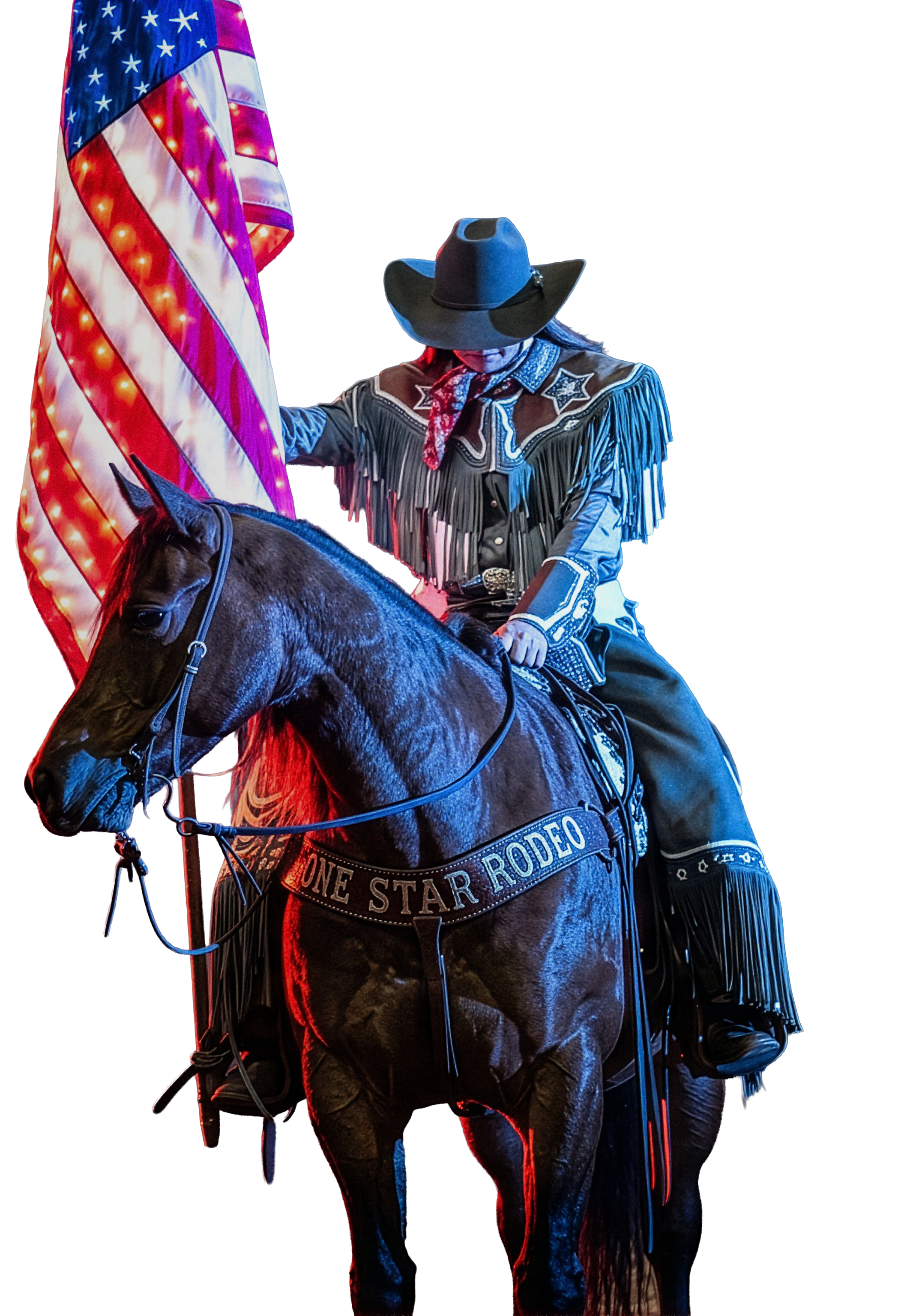 A person in rodeo attire sitting on a black horse next to an American flag with colorful lights.