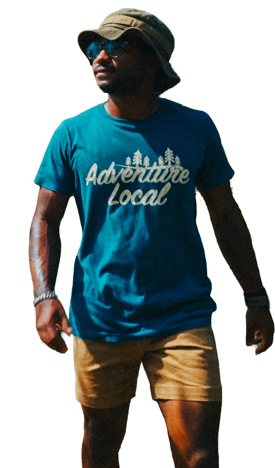 A man wearing a tan bucket hat, sunglasses, a blue T-shirt with 'Adventure Local' and trees printed on it, and tan shorts.