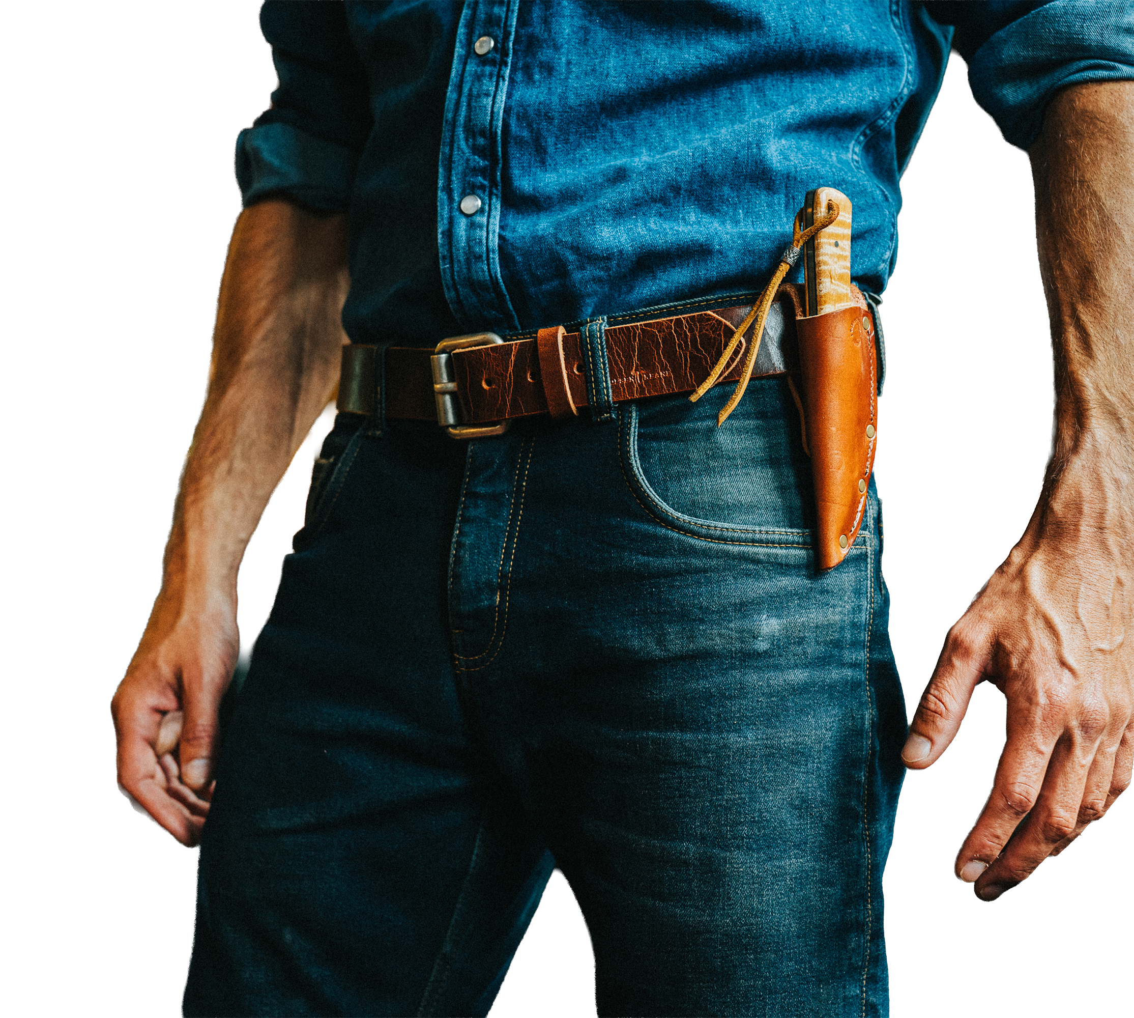 Close-up of a person wearing a denim shirt with a leather holster and a knife tucked into it, with only the torso and part of the arm visible.