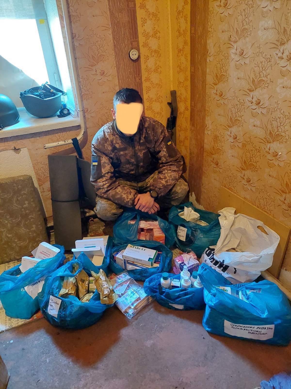 A soldier with the Ukrainian army, with various medical supplies