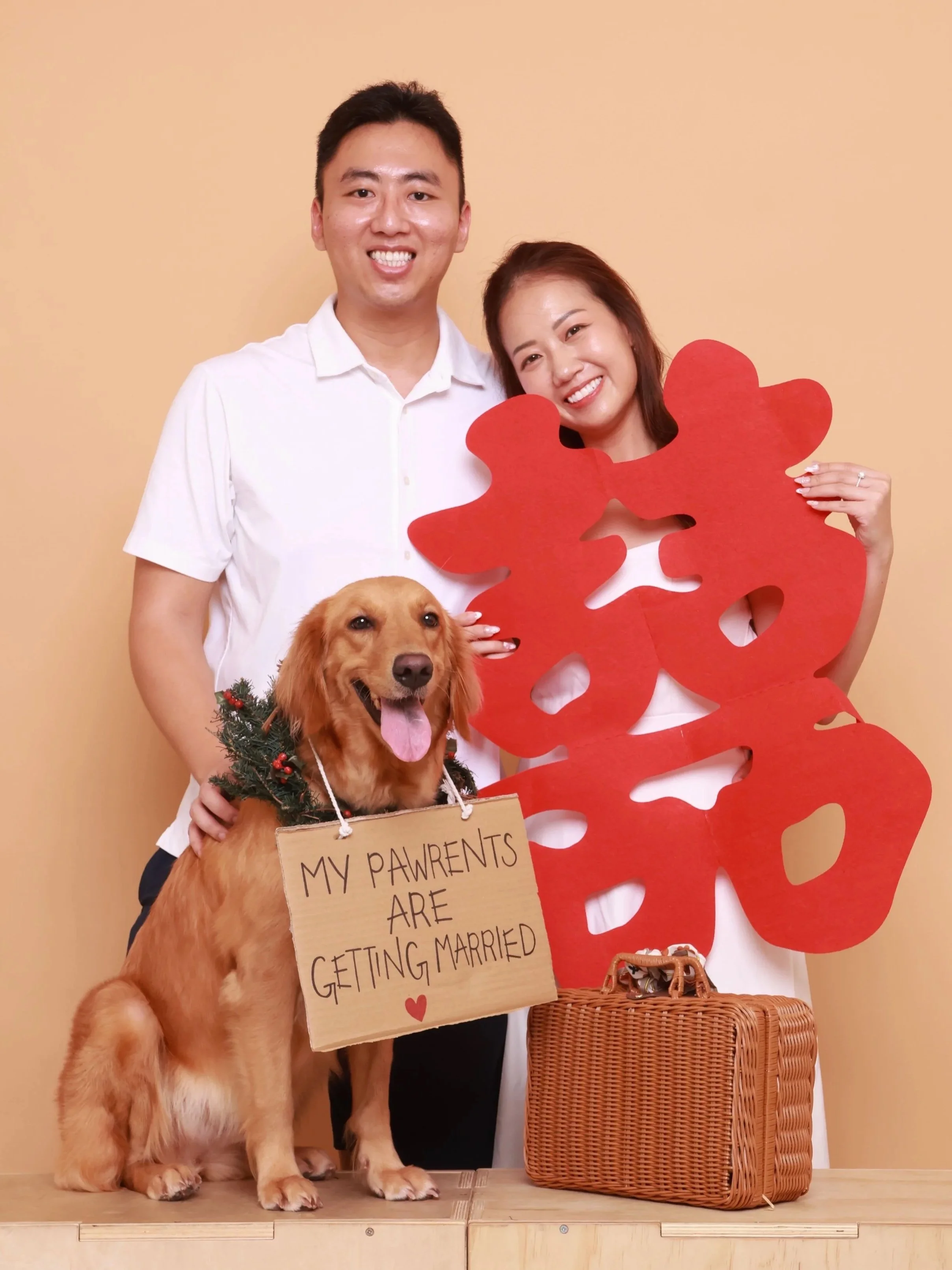 Couple in a romantic pose with two dogs