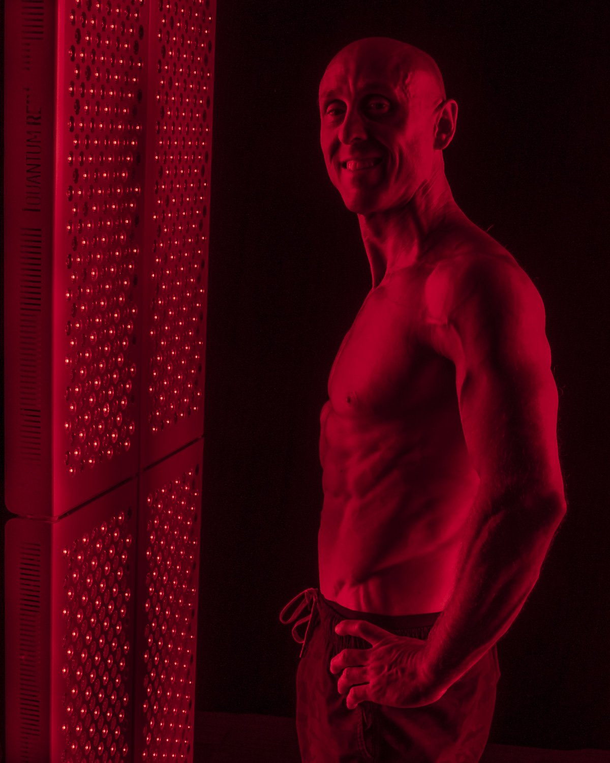 quantum red | red light therapy scottsdale | quantrum red owner jake weeks standing in front of red light panels.jpg