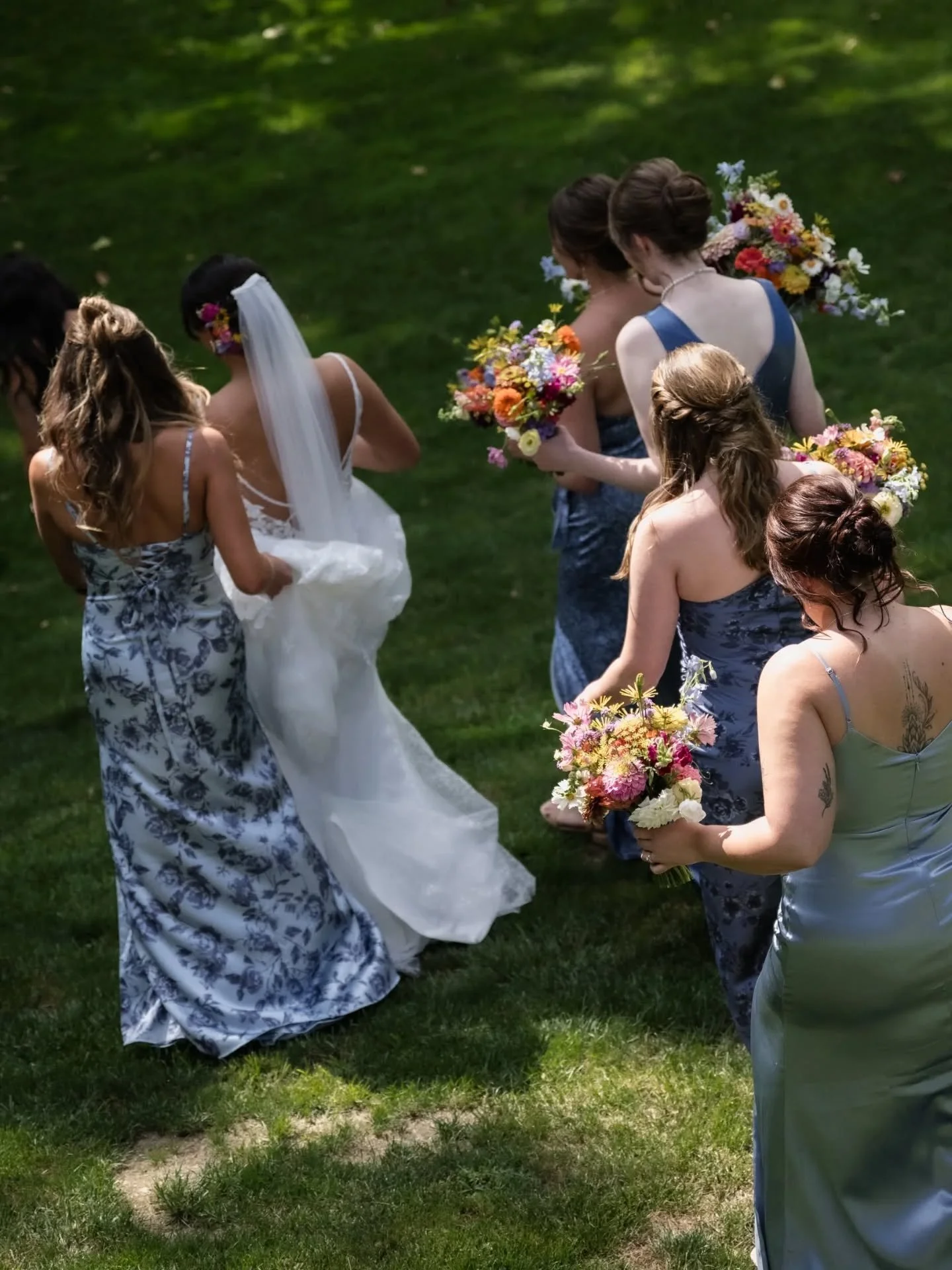 Remembering warmer days filled with sunshine and flowers on this bright but frigid winter morning. 

I love the colorful wildflower bouquets against the slate blue dresses for Jessica's girls. Playful summer blooms will be here again before we know i