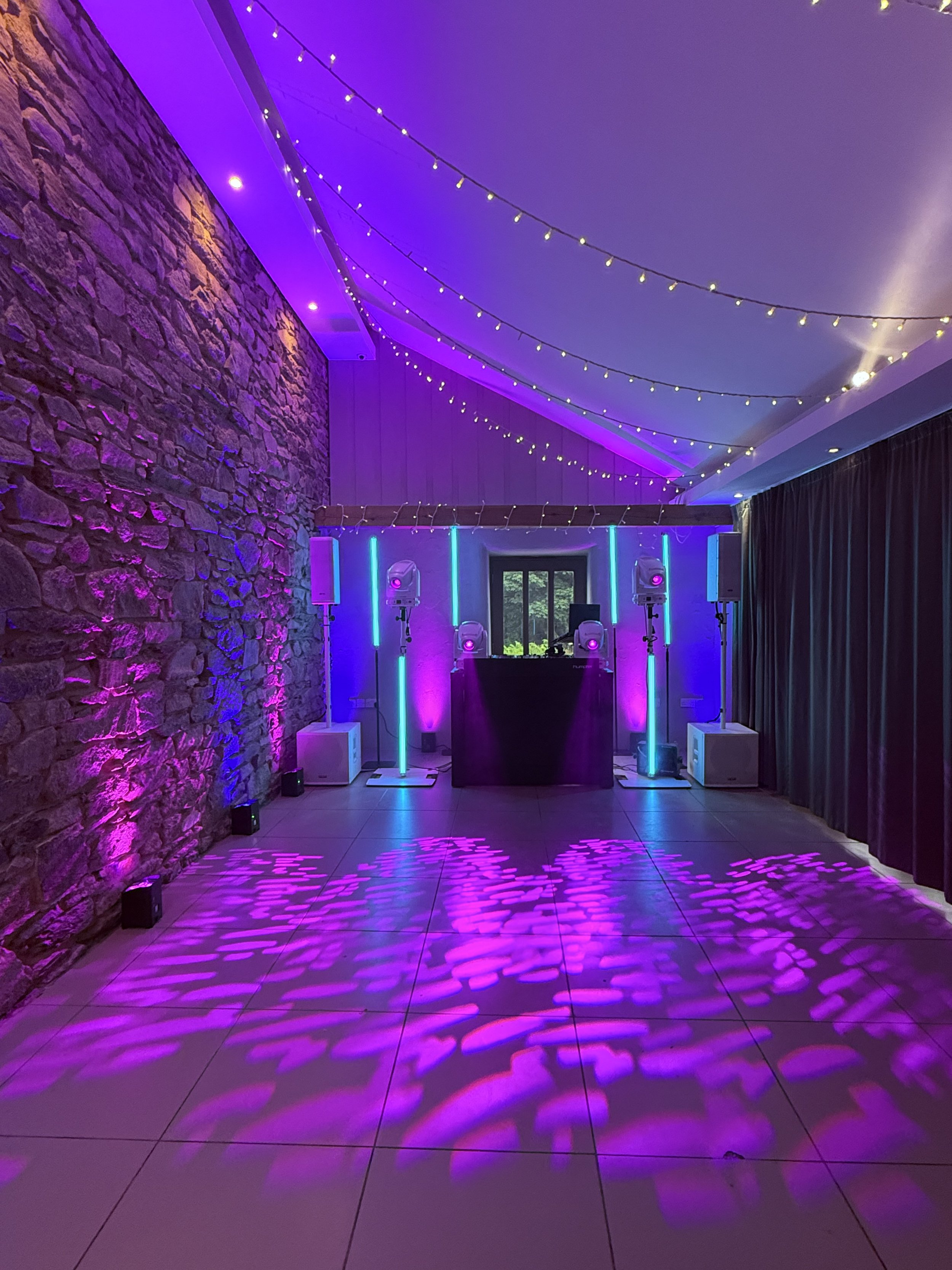 TREVENNA BARNS  ST NEOT DJ setup with lighting and venue uplighting.