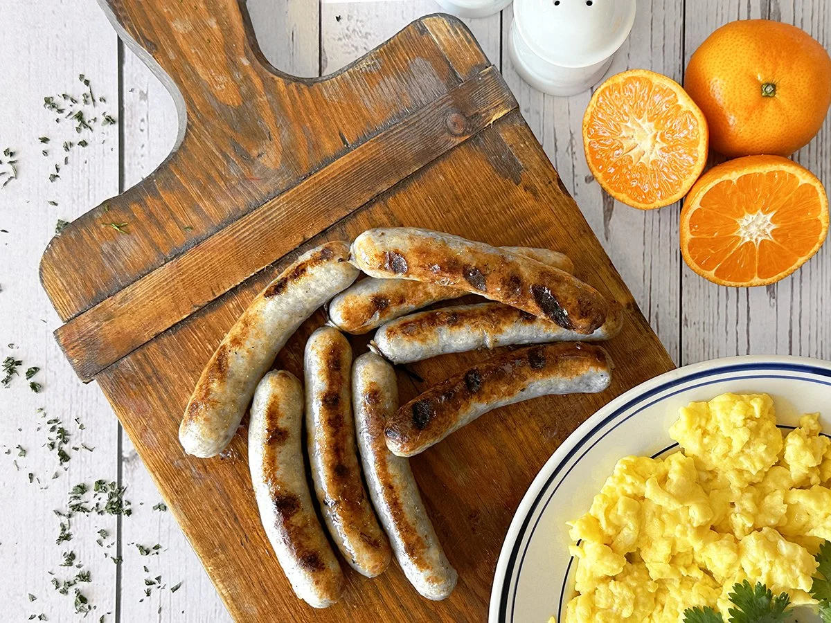 Thumann's Breakfast Diner Sausage with eggs and fruit.