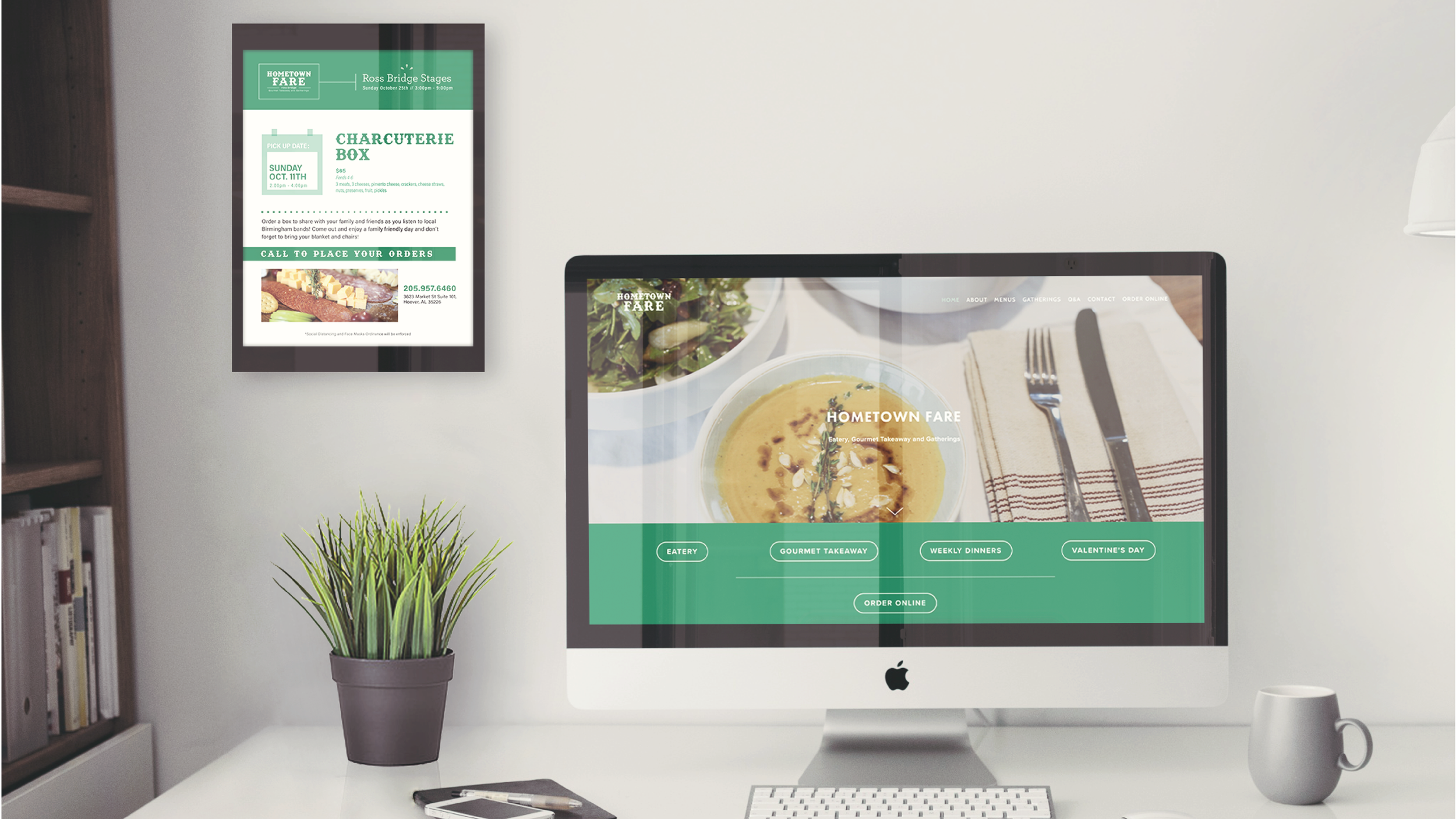 A desktop computer displaying the website of Hometown Fare, a restaurant, with a bowl of soup and utensils on a napkin in the background. A framed flyer for a Charcuterie Box event is on the wall behind the computer, and a green plant in a pot is on 