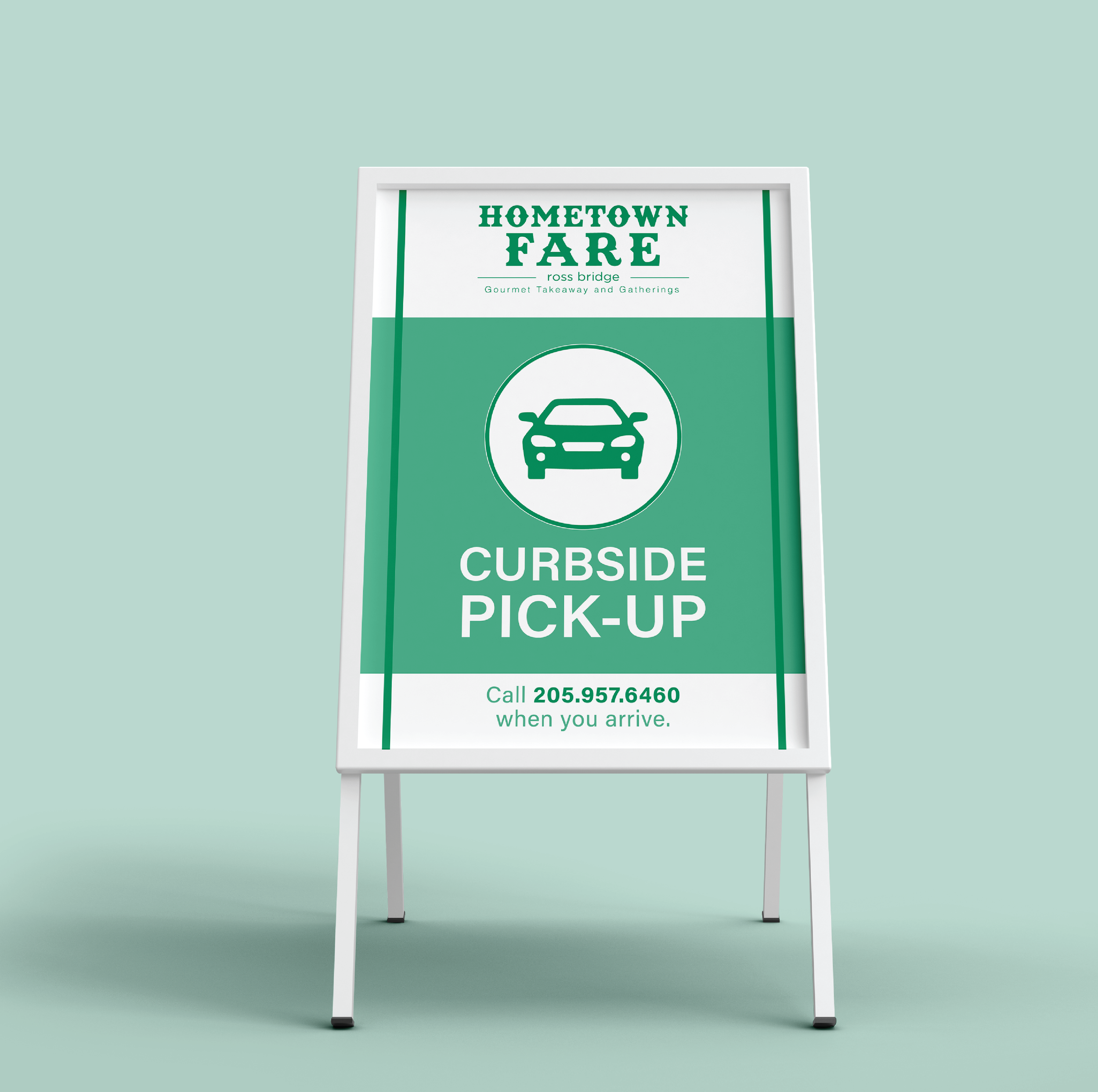 A sign for curbside pick-up at Hometown Fare, with a car icon, phone number, and instructions to call when arriving.