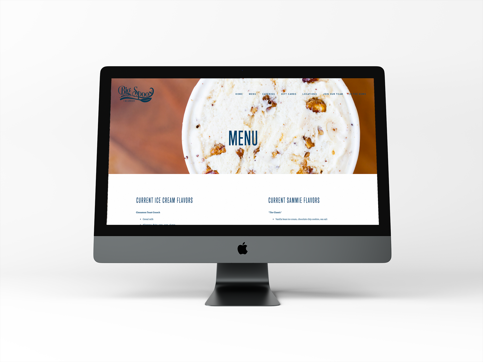 Computer monitor displaying a menu webpage for Big Spoon Creamery with an image of ice cream and sections for current ice cream and Sammie flavors.