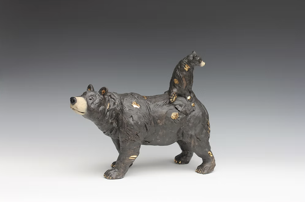 An original handbuilt ceramic sculpture by British ceramicist Jack Durling of a black bear mother with her cheeky cub riding piggy-back.