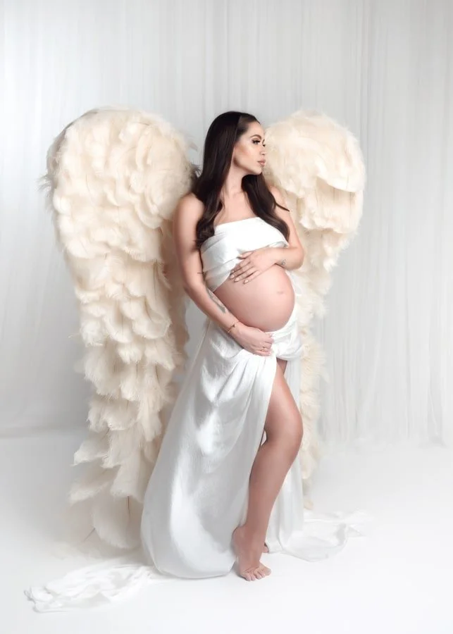 Capturing the glow of a soon-to-be mom with her baby bump and angel wings