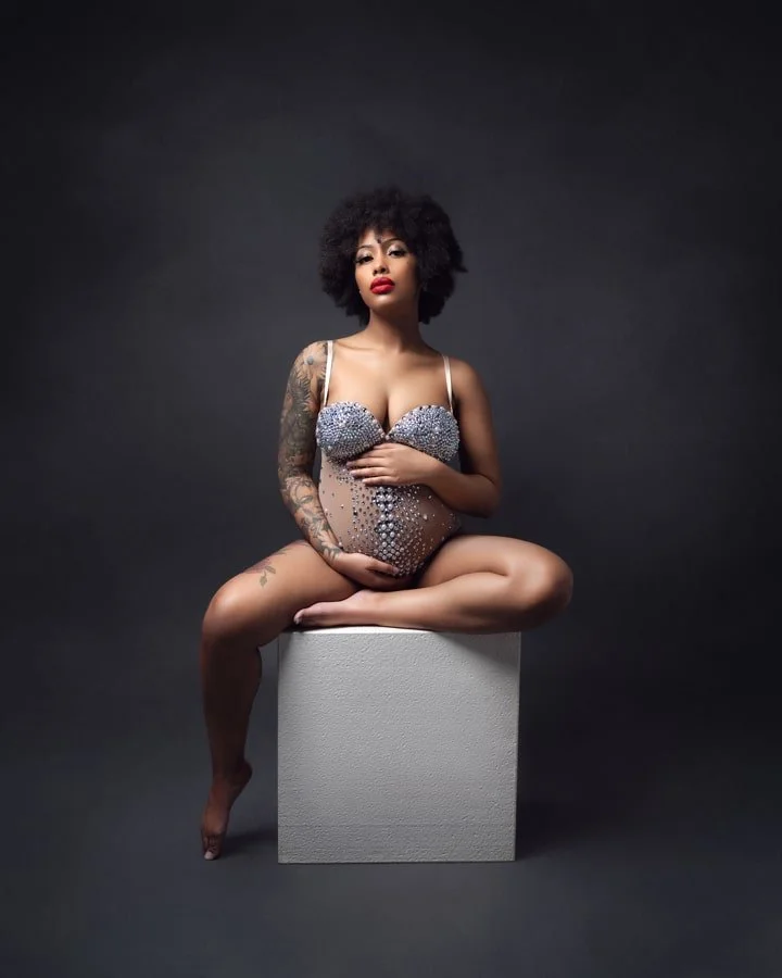 Sensual boudoir maternity photography Vancouver showing a happy expectant mother 
