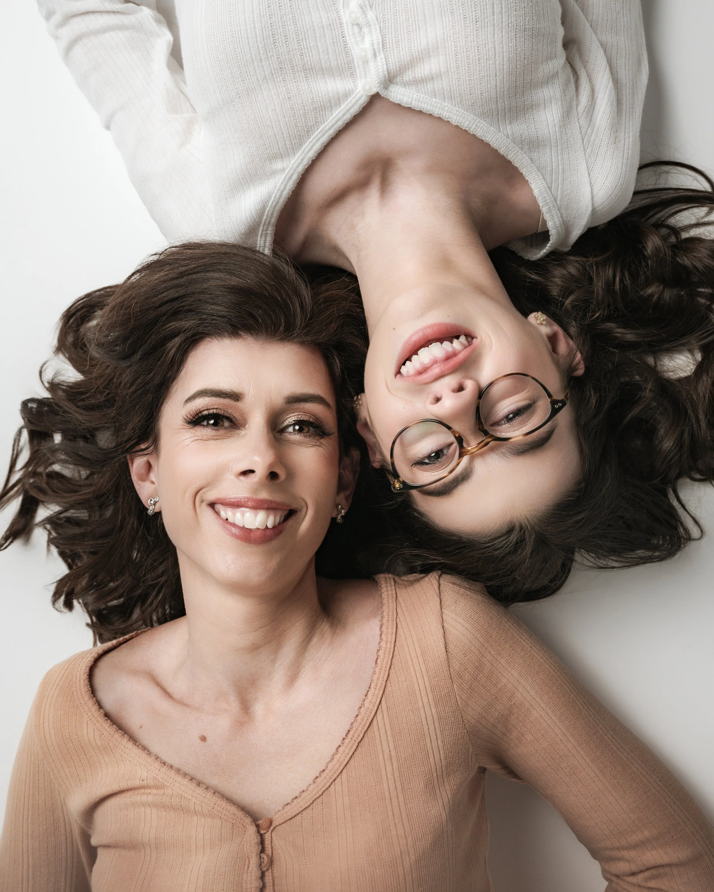 Mother and daughter lying on the bed