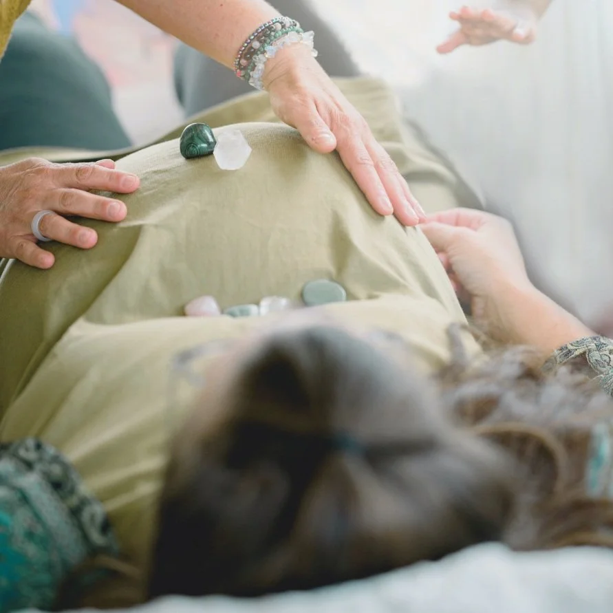 Pregnant women receiving a hands-on blessing
