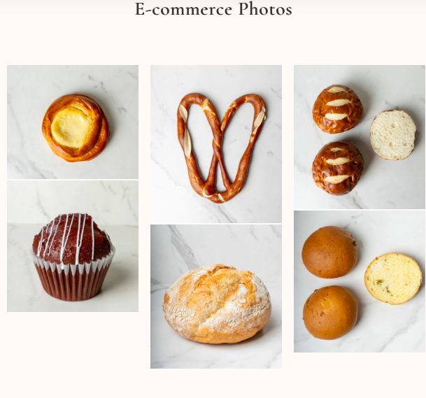 A selection of baked goods including a cheese Danish pastry, pretzels with white icing drizzle, cream-filled pastries, a chocolate muffin, a bread roll, and a couple of croquettes.