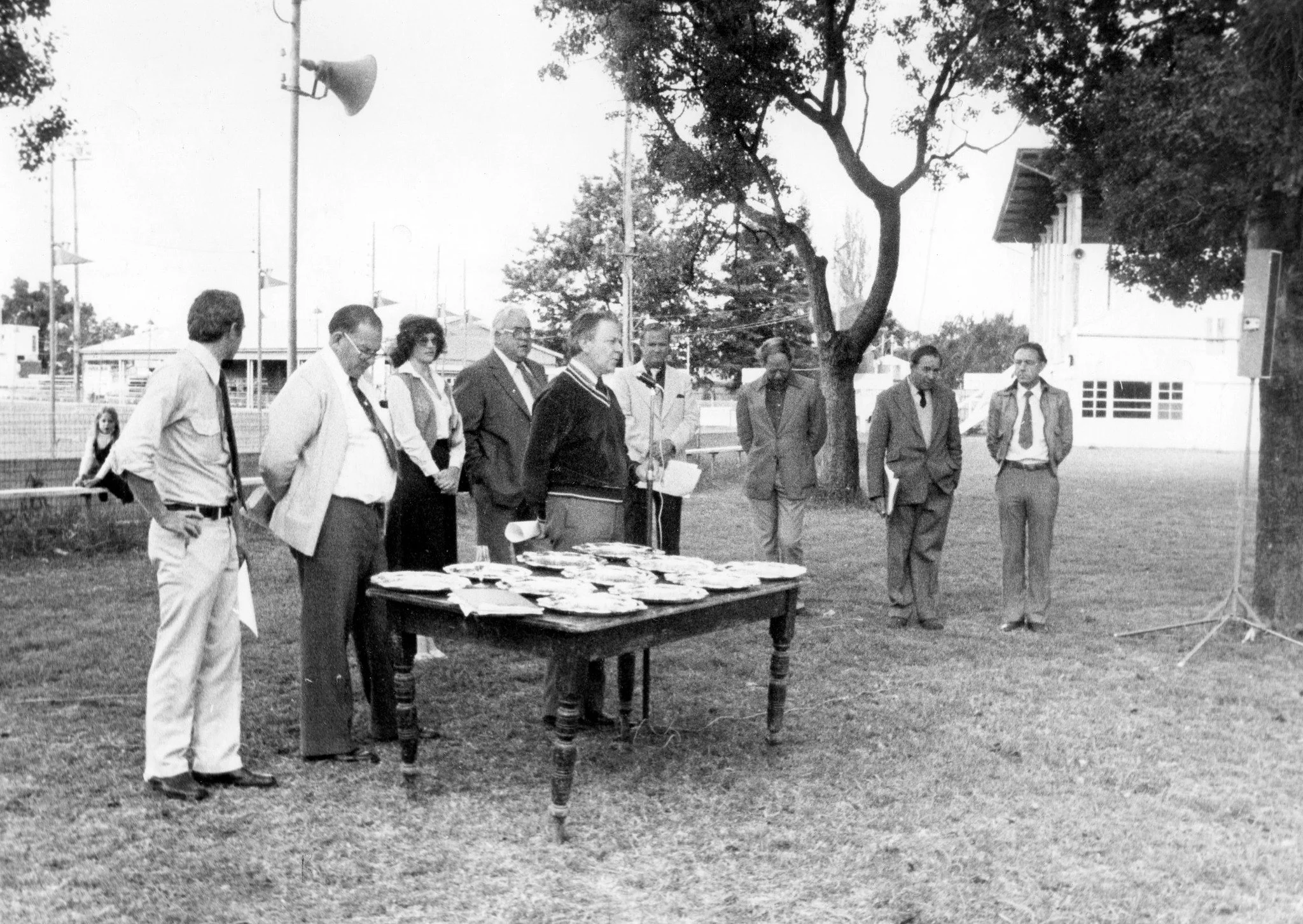 Step back in time to the Trophy judging and presentation of 1979! This iconic black and white photograph captures the essence of a show already rich in tradition. From the classic 1970s attire to the table laden with silver, it's a powerful piece of 