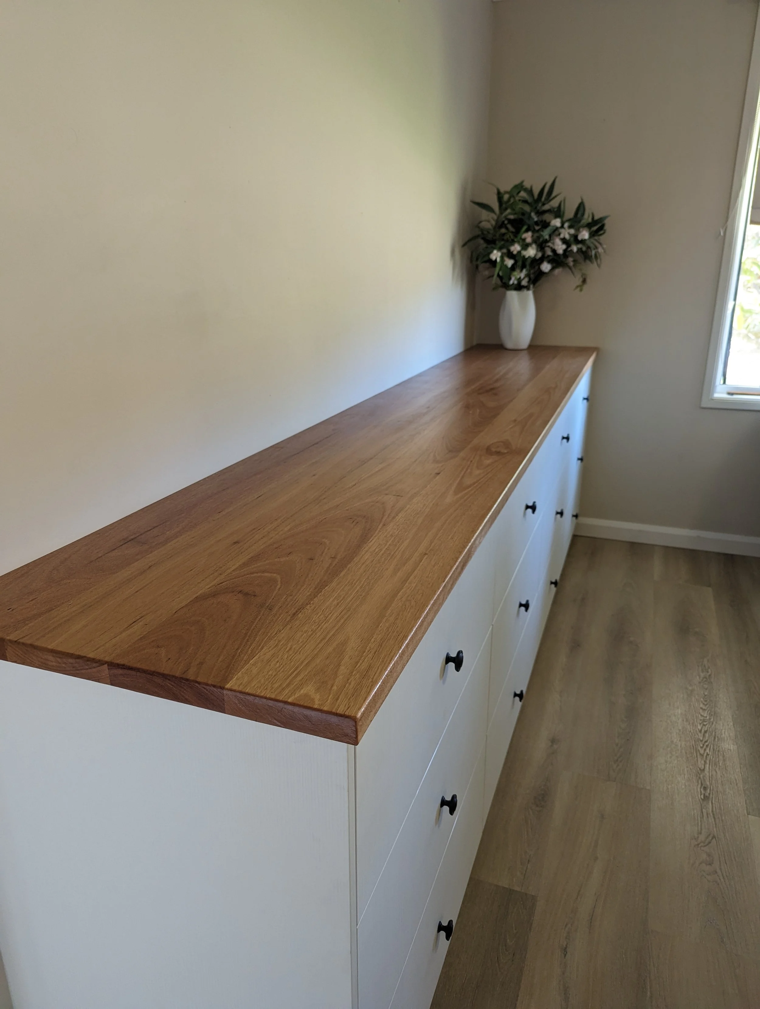large custom made set of drawers for bedroom storage with blackbutt timber benchtop
