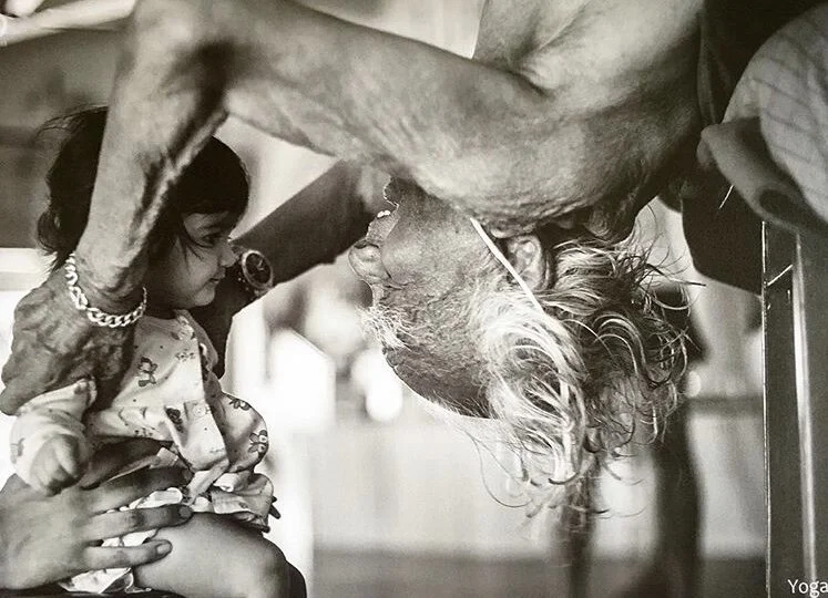 BKS Iyengar playing with his great granddaughter while he practices yoga
