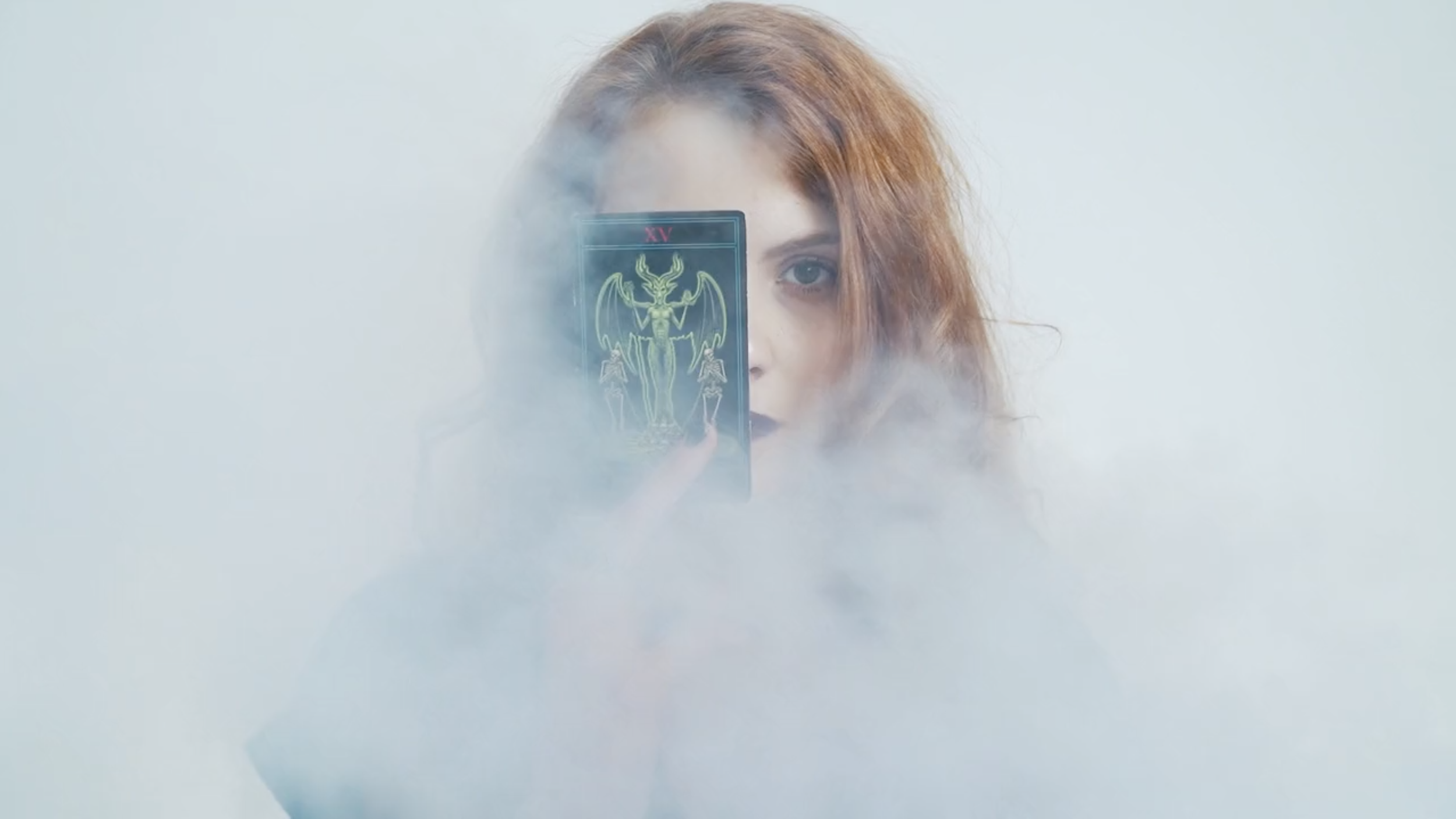 WOMAN IN SMOKE HOLDING CARD PHOTO.png