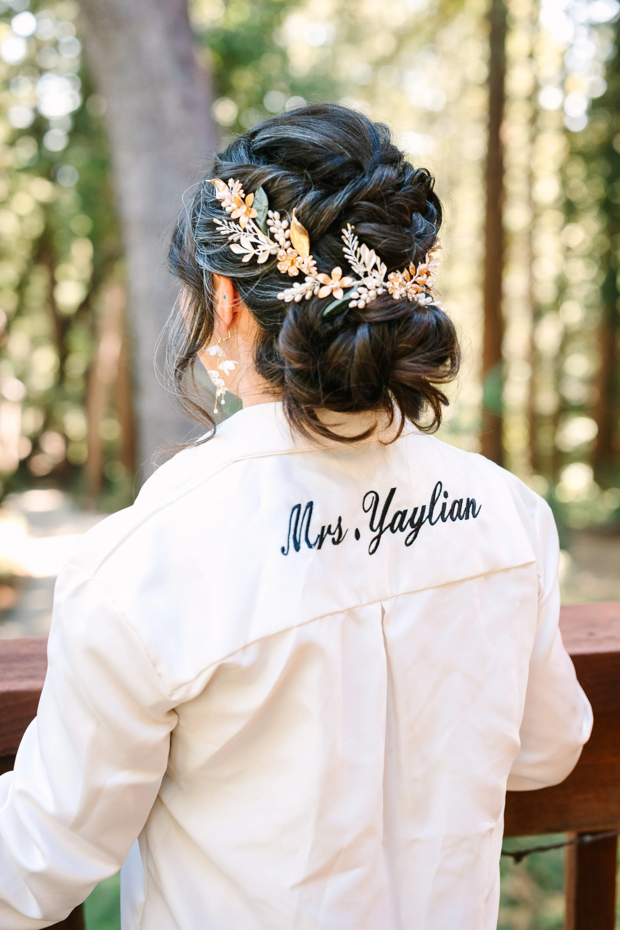 Bride with romantic, textured, updo and gold hairpiece during a redwood forest, wedding featuring natural bridal makeup and soft glam styling. Romantic BoHo up style. Romantic braided up style romantic twisted up style. Bridal hairstyle for thick hai