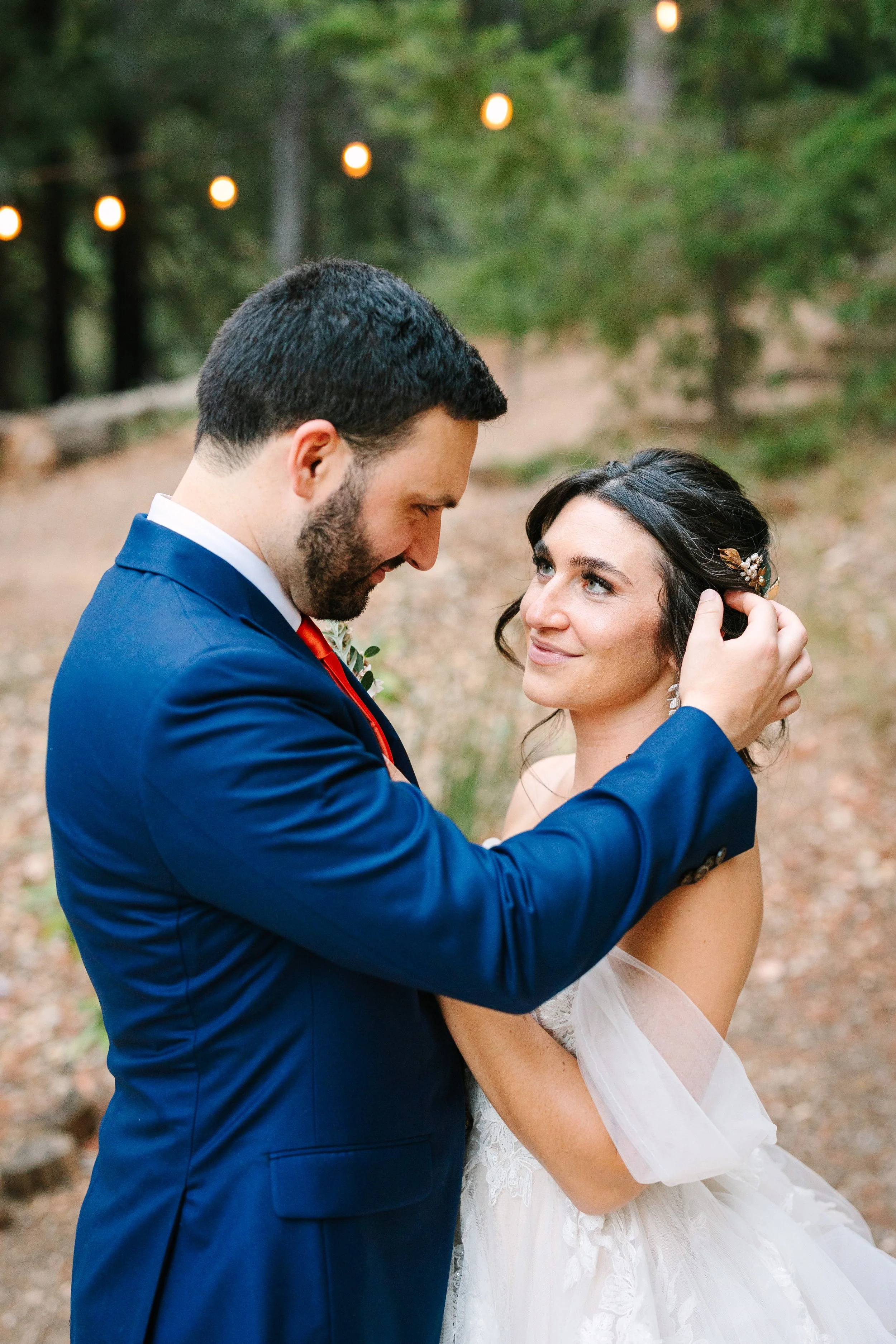 After getting ready, the couple shared a quiet moment among the redwoods, her soft glam, bridal makeup and romantic, textured updo with delicate gold hairpieces created an effortlessly elegant look that complimented the natural forest setting. Romant