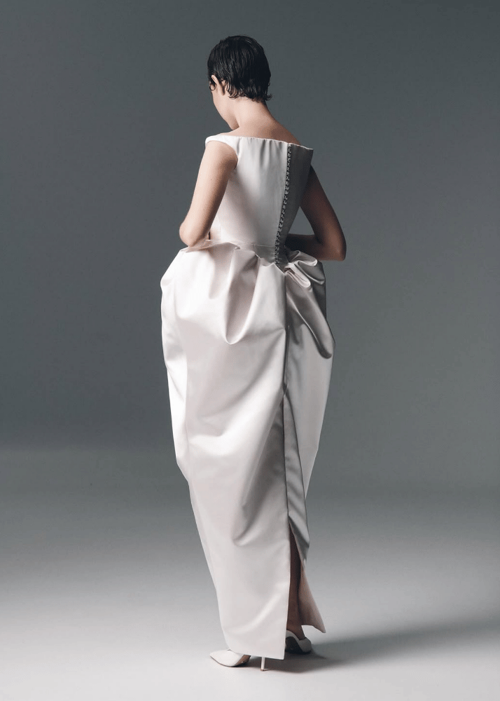 Minimalist Australian designer wedding dress featuring a high back and voluminous column skirt.