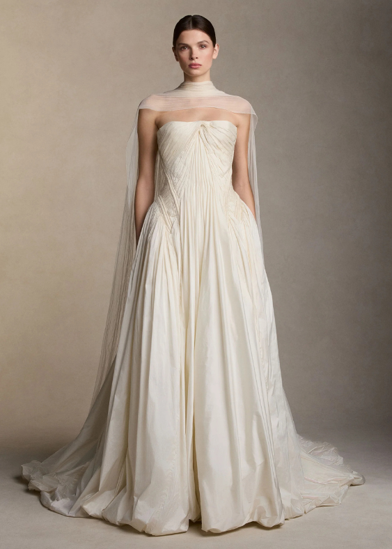 A front view of minimalist, modern, Australian Bride wearing a draped bridal scarf on a neutral background with a contemporary bridal gown by Australian Designer Danielle Frankel, exclusively stocked at Bloom Australia.