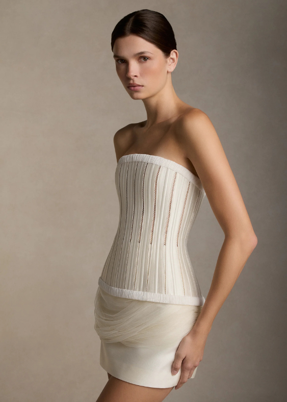 A close up of a woman standing on the side with a modern, sleek, boned bridal bodice by contemporary designer Danielle Frankel, stocked exclusively at Bloom Australia.