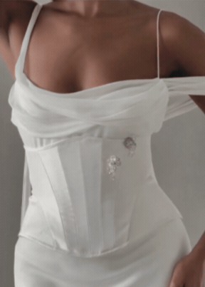 GIF of a  Contemporary Australian designer wedding dress featuring a draped silk chiffon neckline and layered with a structured waist cincer with crystal details