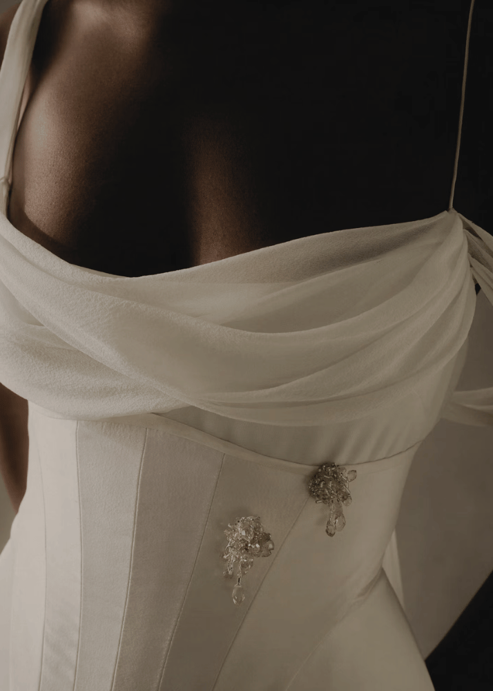 Close up of a modern luxury Australian bridal gown featuring  silk crepe bodice and crystal detailing.