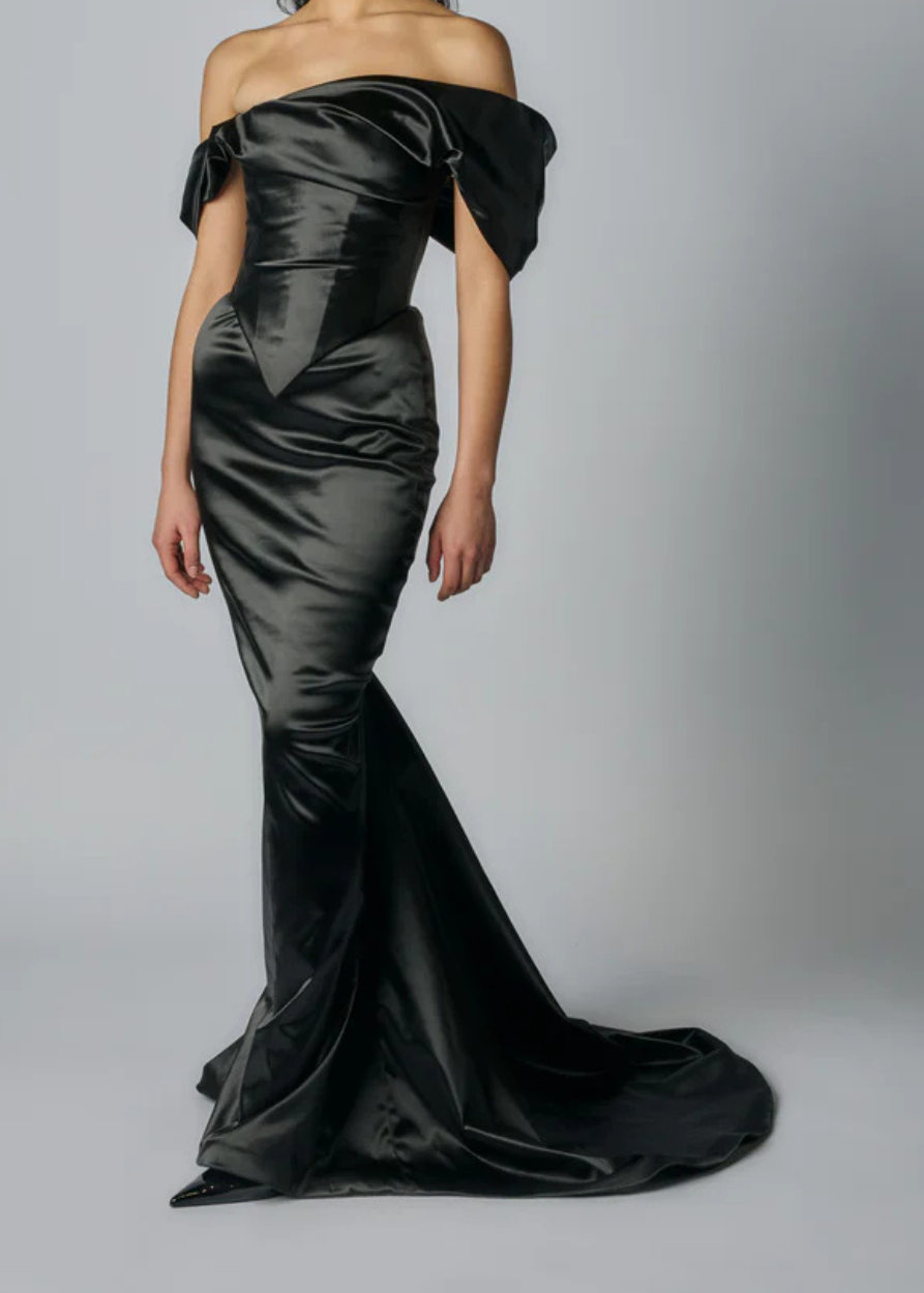 close up of a modern bridal skirt that is sleek, form fitting and sophisticated.  Bride is standing with a white background.