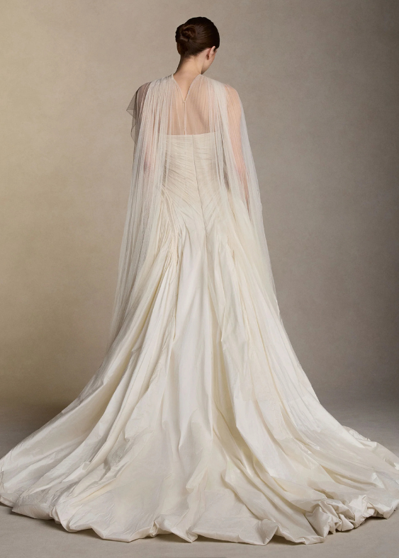 The back profile of a woman with a modern bridal scarf with button detail standing with a contemporary bridal dress for her Australian wedding.