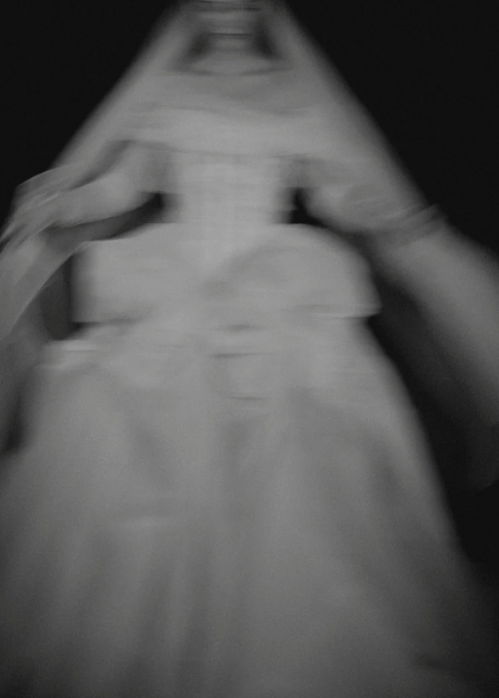 Modern, contemporary, fashion forward image of a Bloom bride on a black background.