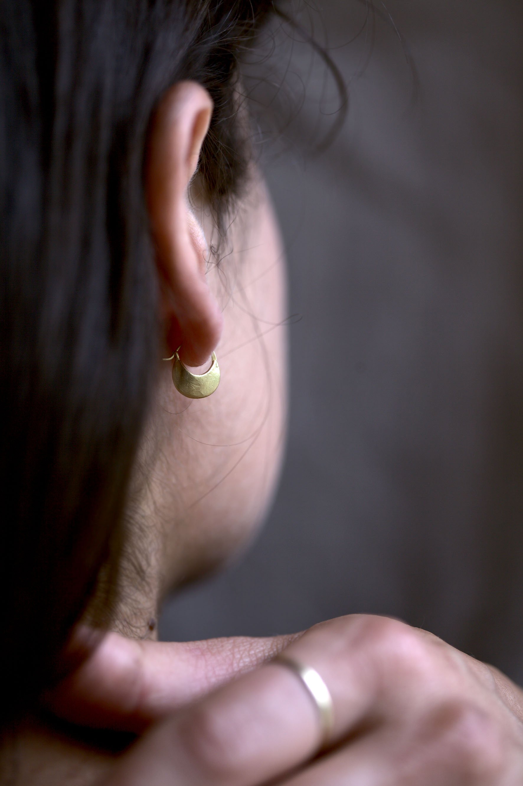 Close up portrait photograph by Hatty Frances Bell of ear and gold hoop earring shot from behind