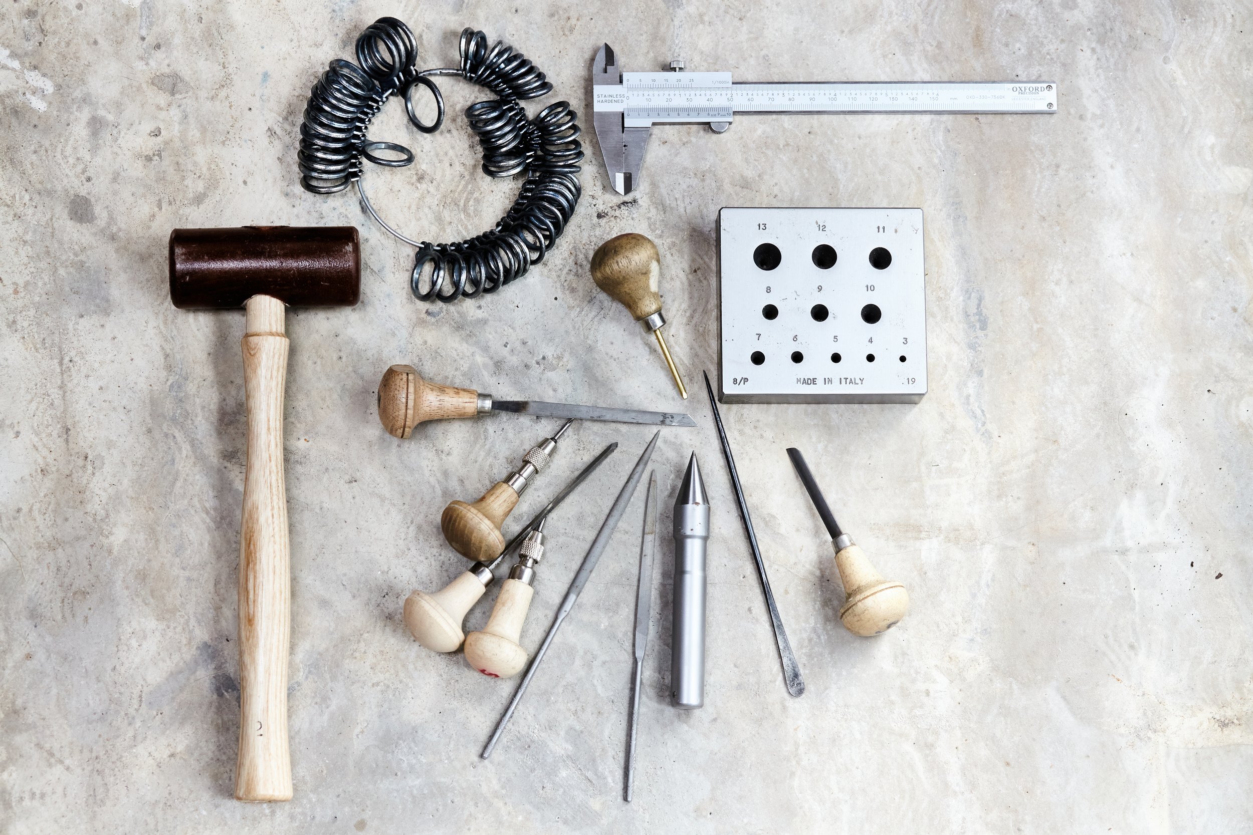 Still life photograph by Hatty Frances Bell of Heidi Hockenjo's tools on a concrete floor in Stroud