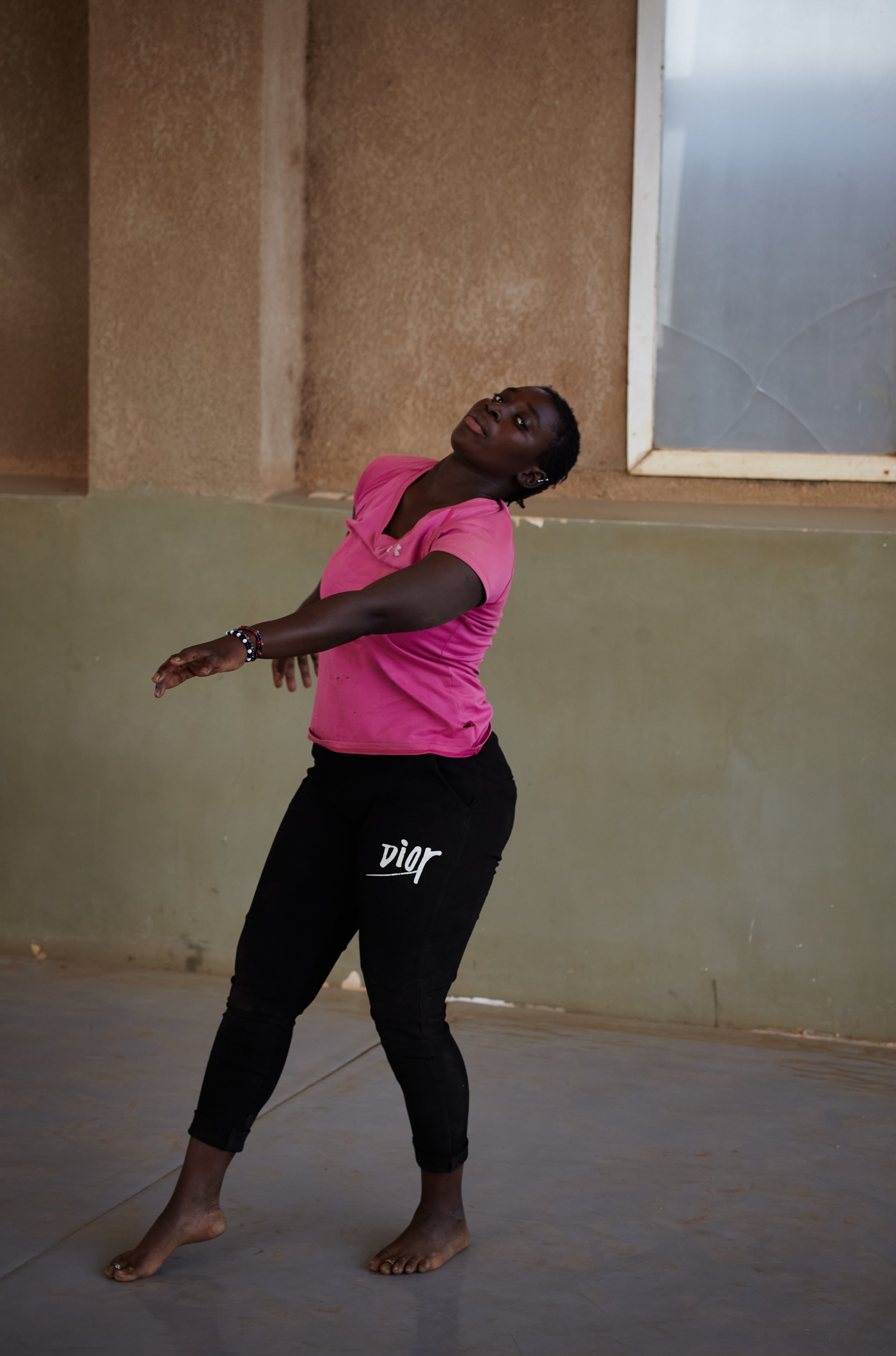 Photograph by Hatty Frances Bell of a girl in a pink t-shirt dancing in the studio at Ecoles Des Sables