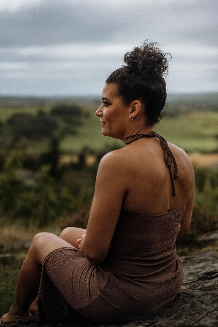 Nina, Nurtured Through Nature. Nina is facing away from the camera and looking out into the distance.