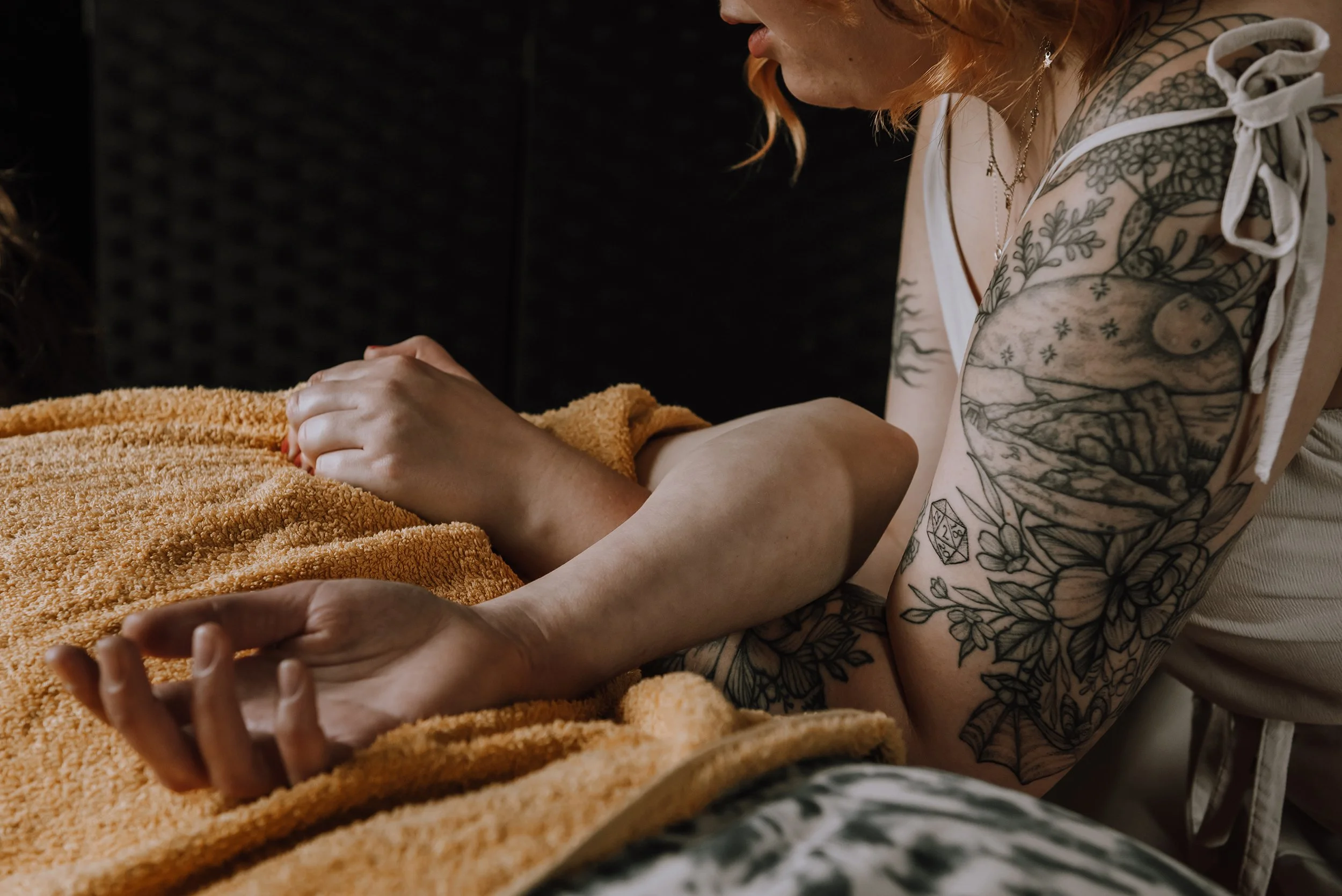 Close up of arms intertwined during a massage.