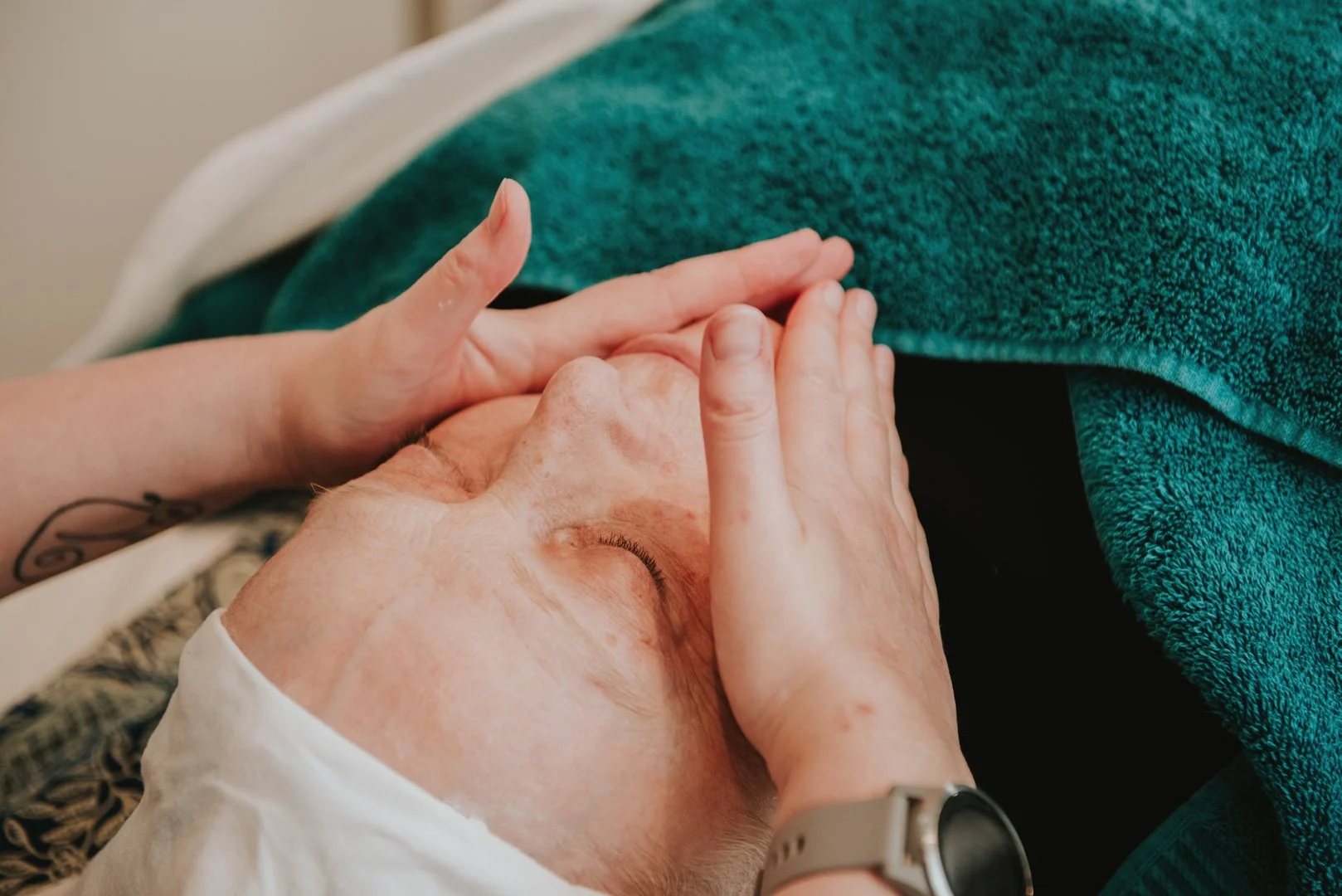 Close up of hands performing a facial. For Vikki at Chameleon Acupuncture 