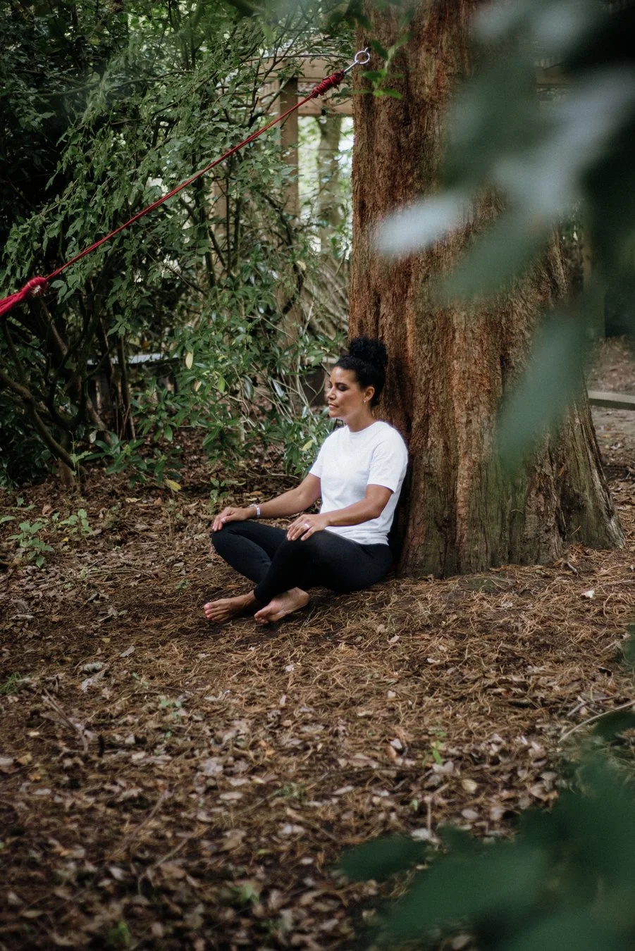 Nina, Nurtured Through Nature. Nina is meditating in the forest.