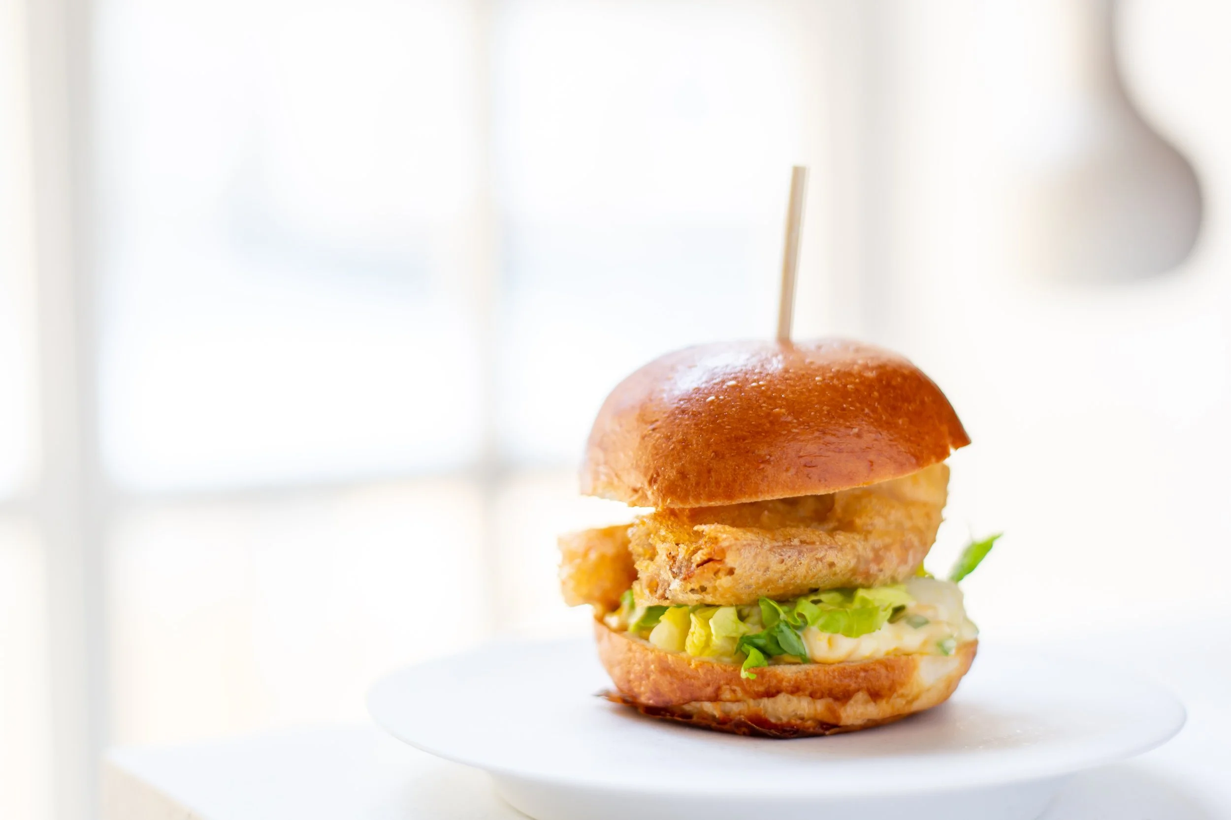 Fish Burger on white plate Tramshed Food Photography