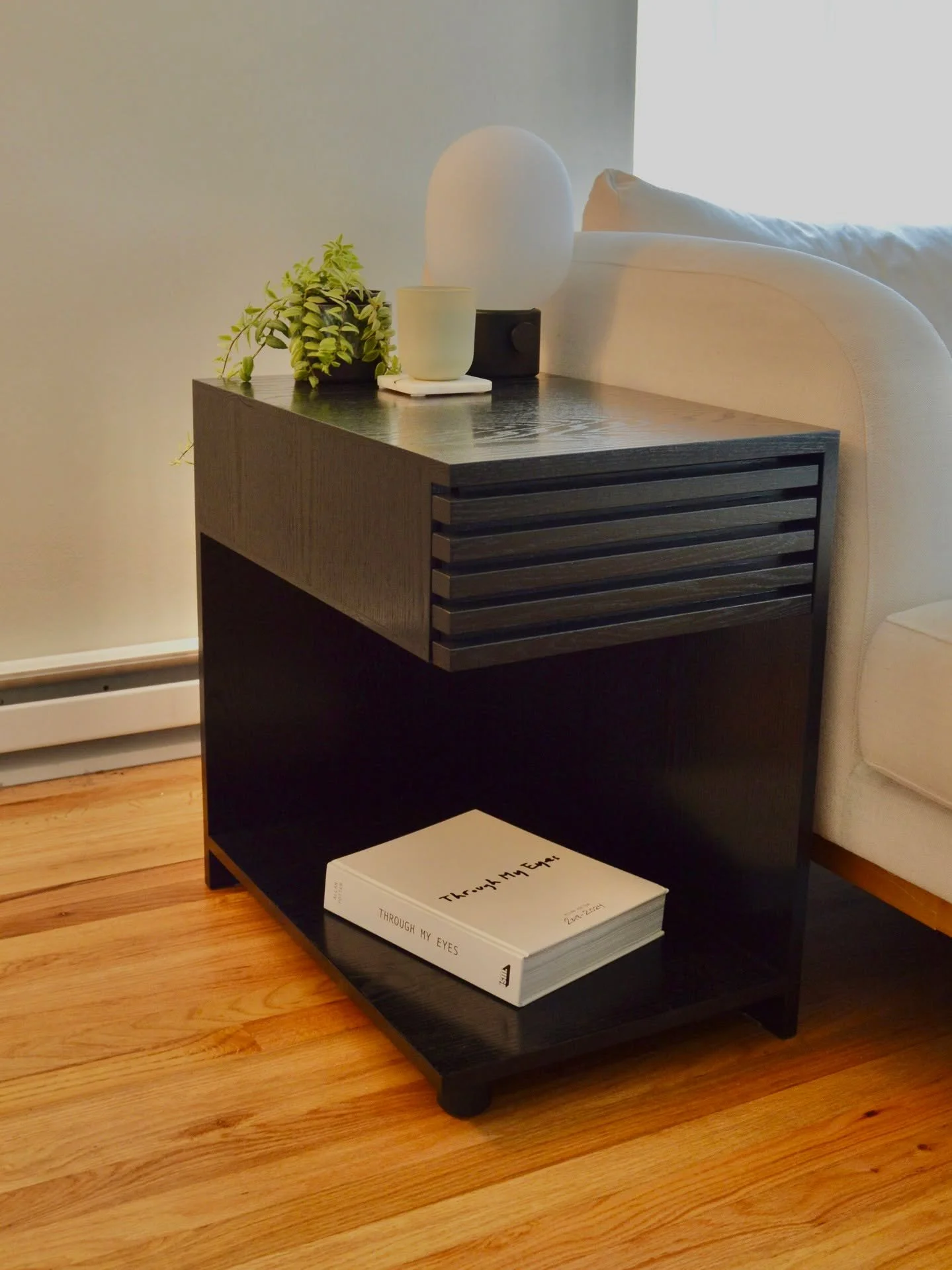 Recently wrapped up this side table and matching media console. 

Some may find it contentious to stain solid wood like this. However, the red oak's beautiful grain texture stole the show with the application of @generalfinishes black wood stain.