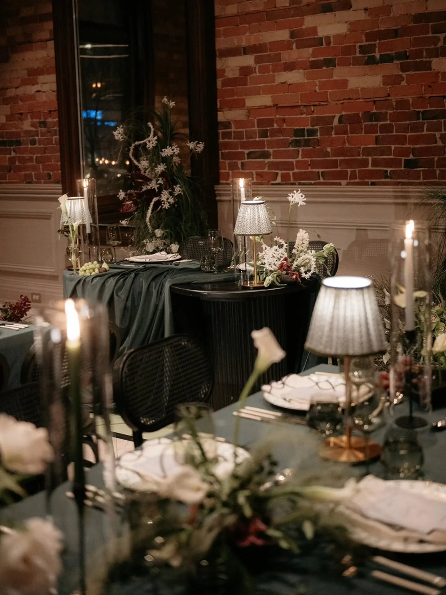 We designed an intimate winter wedding at the Gladstone Hotel that exuded moody romance and felt rooted to the venue's character. With deep green velvet linens, table lamps, and unique centrepieces, Laura and Rowan's reception details were both authe