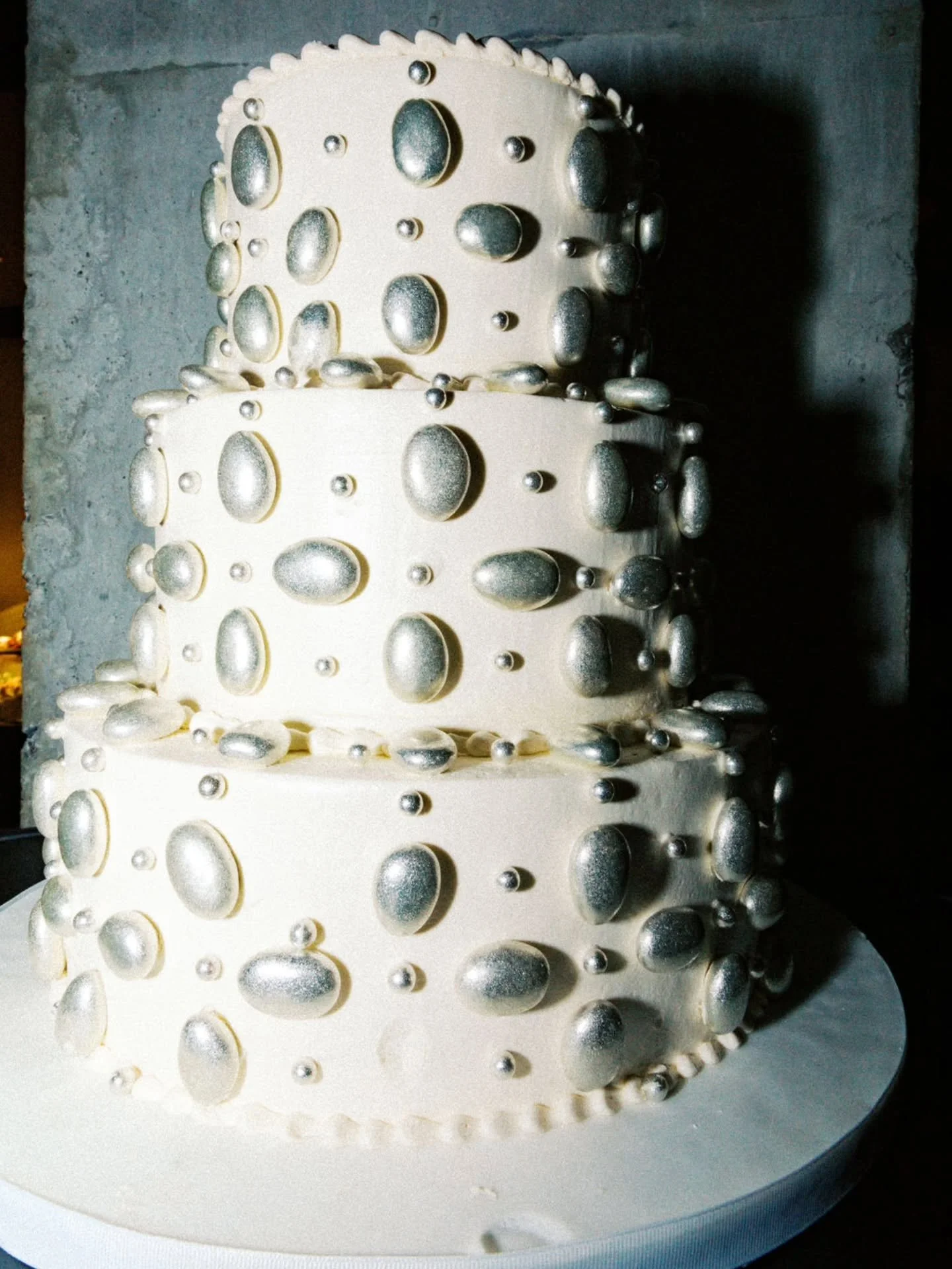 Obsessed with Sarah and James' wedding cake. The oversized silver bead detailing brings a fresh, chic, and modern twist to a timeless design. ✨️

Wedding Management @madbashgrp 
Cake @justtemptations
Photography @laurenrosenauphotography
