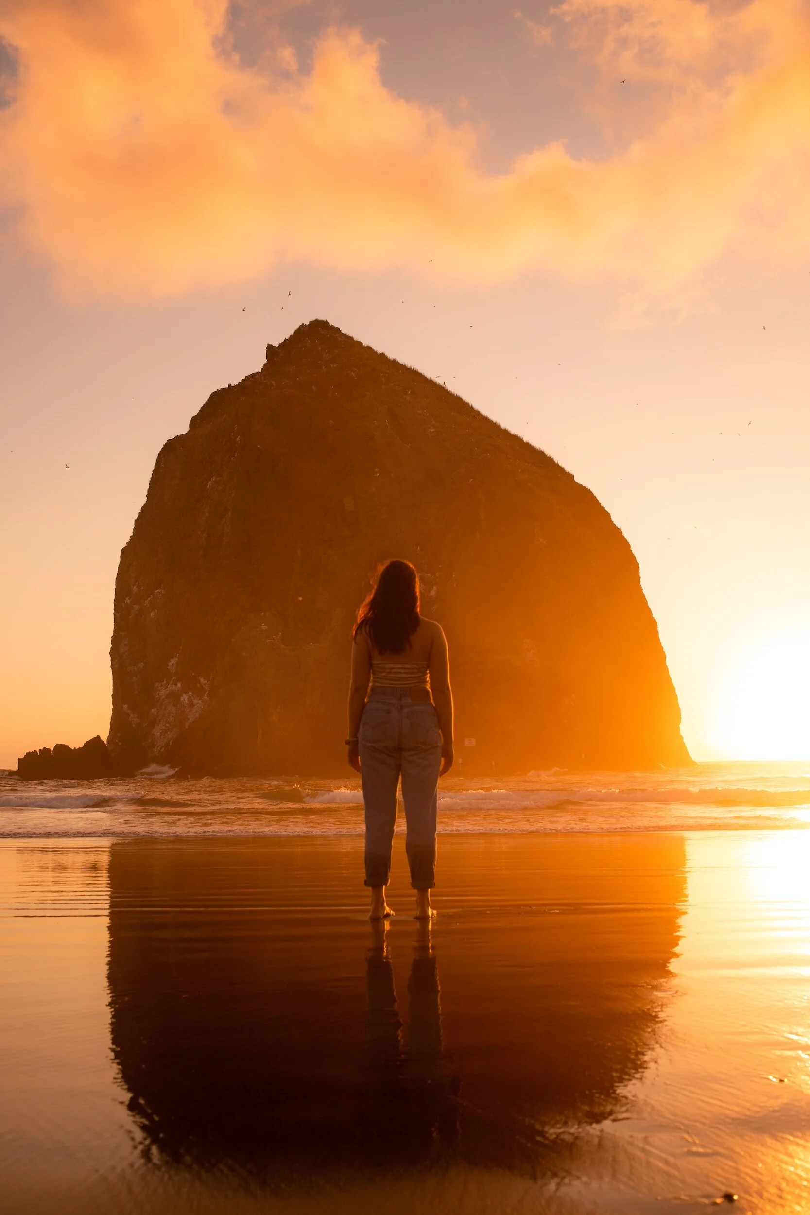 A woman in a meditative state at the beach working through triggers from her past