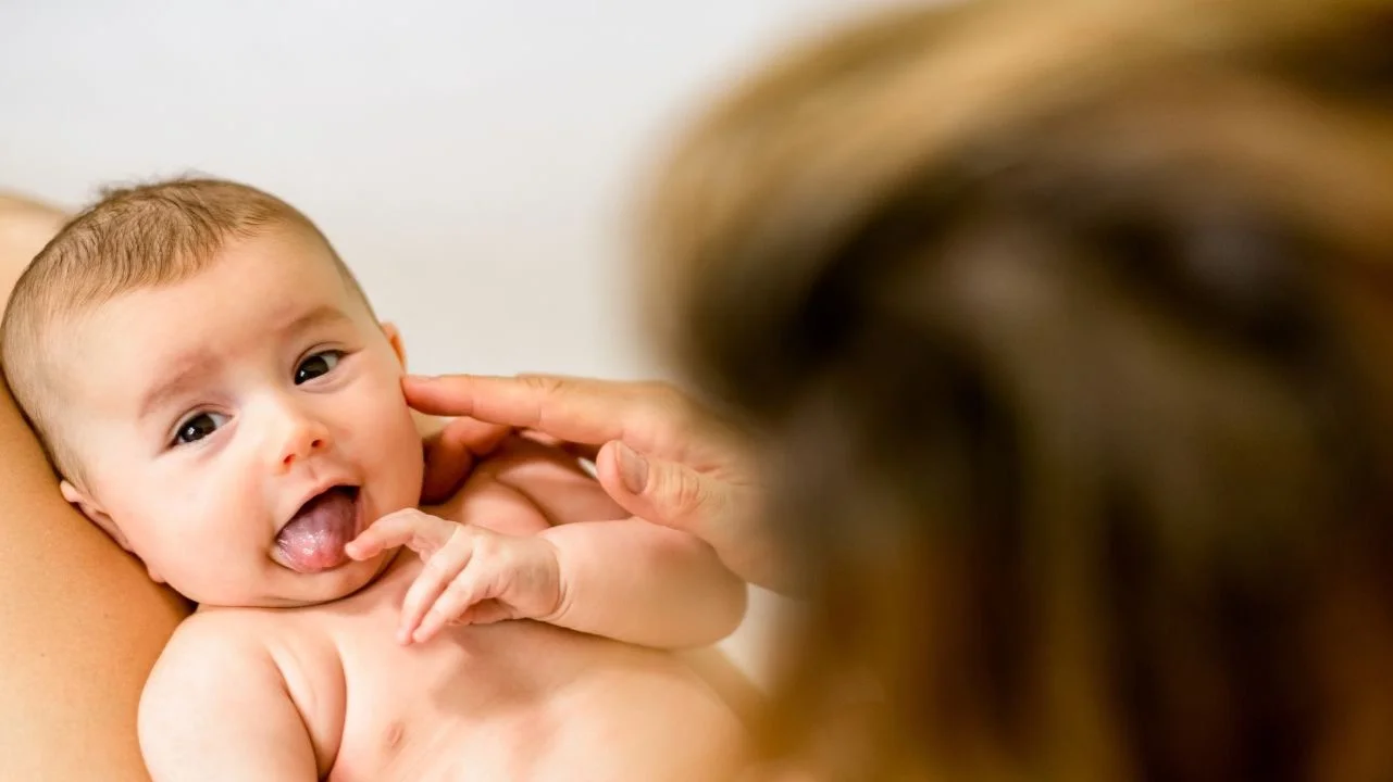 baby sticking out tongue