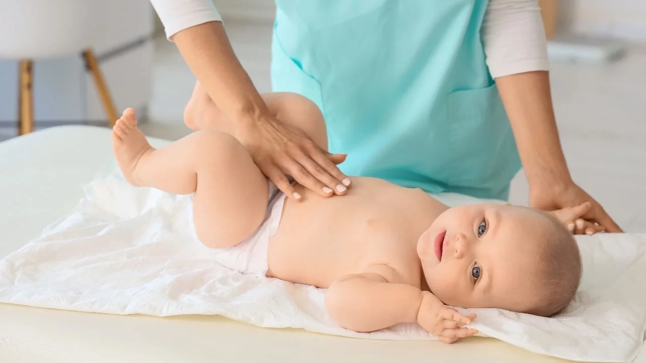 baby getting massaged on its belly