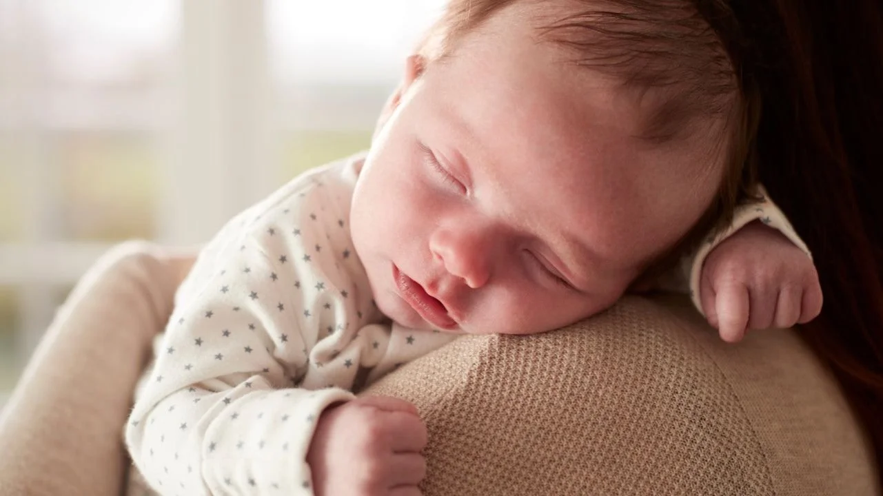 baby asleep on shoulder