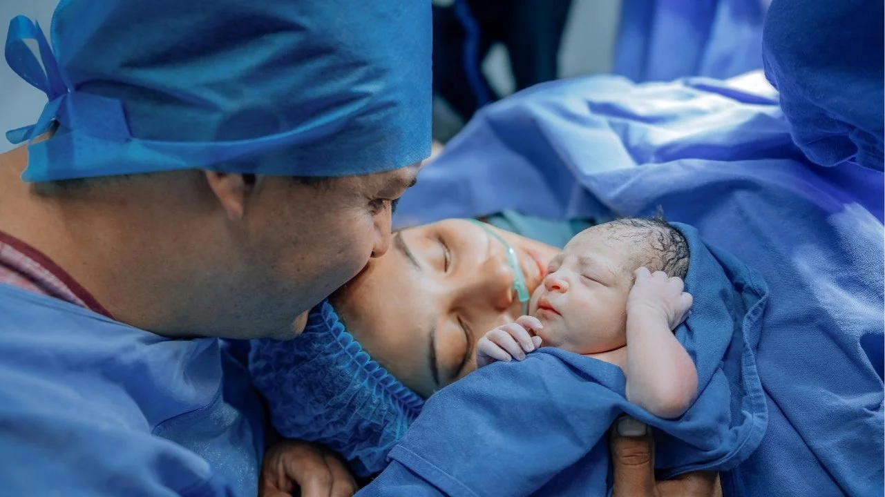 man, woman and baby meeting after c-section delivery